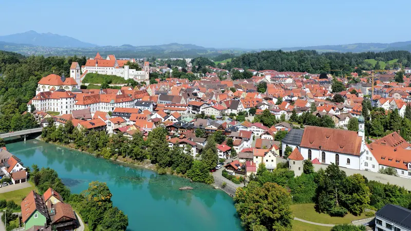 The Hohes Schloss and St. Mang monastery above Füssen's red-roofed old town and the turquoise Lech river
