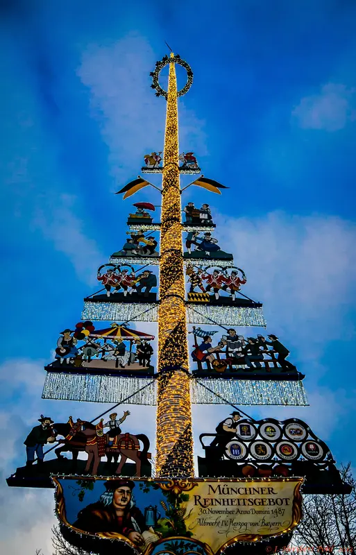 The decorated Maibaum (maypole) rising over the Viktualienmarkt in Munich